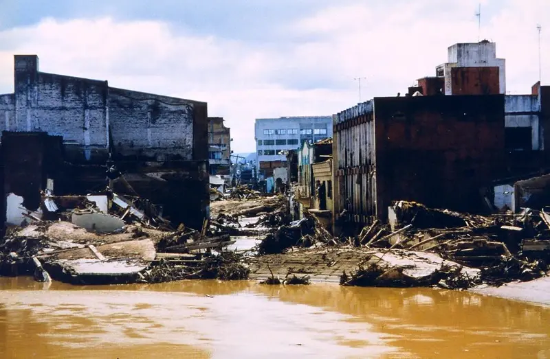 Debris and collapsed buildings line the Choluteca River in Honduras.