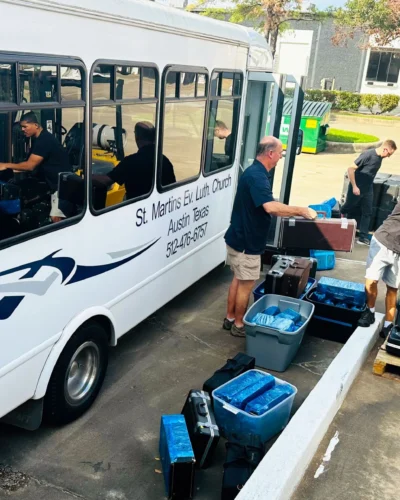 AHH volunteers load donated instruments onto a St. Martin's Ev. Lutheran Church bus en route to Houston, from where they were shipped to Juticalpa in 2024 as part of AHH's music education program, Project Noteworthy.