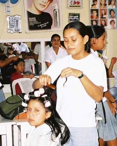 Several children receive haircuts and others wait their turn in a bustling hair salon in Honduras.