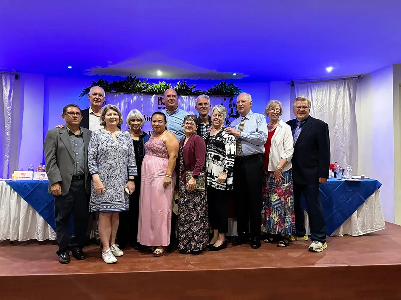 A group of twelve Austin Helps Honduras members and volunteers pose for a photo at the 2024 scholarship banquet in Colonia Solidaridad, Honduras.